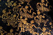 Wat Xieng Thong temple in Luang Prabang, Laos. Detail of the  intricate gold stencilling on black lacquer that decorate the walls of the sim. 